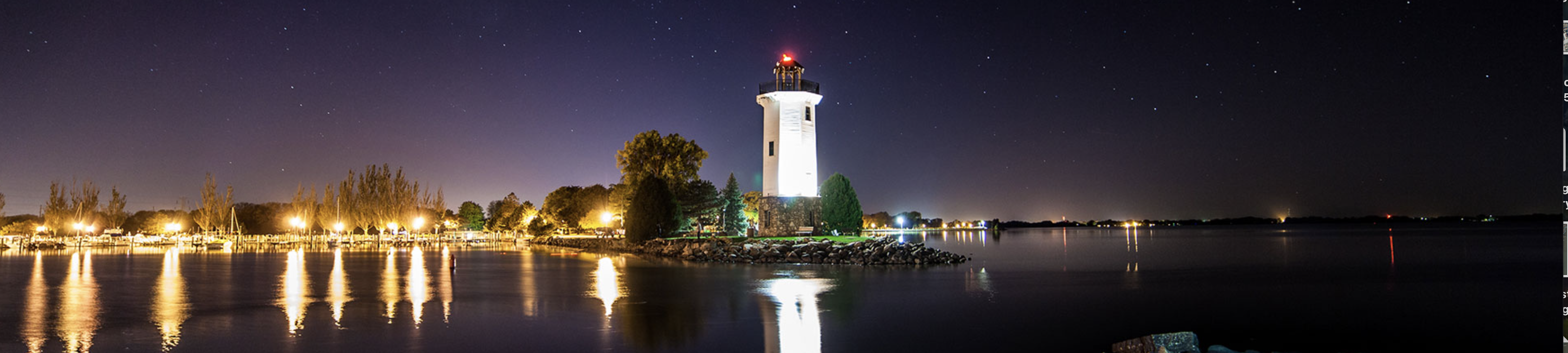 Lighthouse on waterfront with fall colors